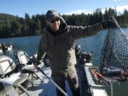 Guide Cameron Black of Woodland cleans a catch of kokanee at Merwin Reservoir for clients in January.