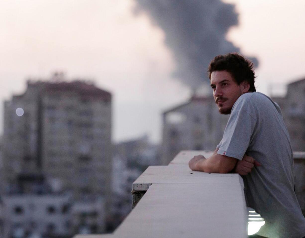 Associated Press video journalist Simone Camilli on a balcony overlooking smoke from Israeli Strikes in Gaza City. Camilli, 35, was killed in an ordnance explosion in the Gaza Strip, on Wednesday  together with Palestinian translator Ali Shehda Abu Afash and three members of the Gaza police.