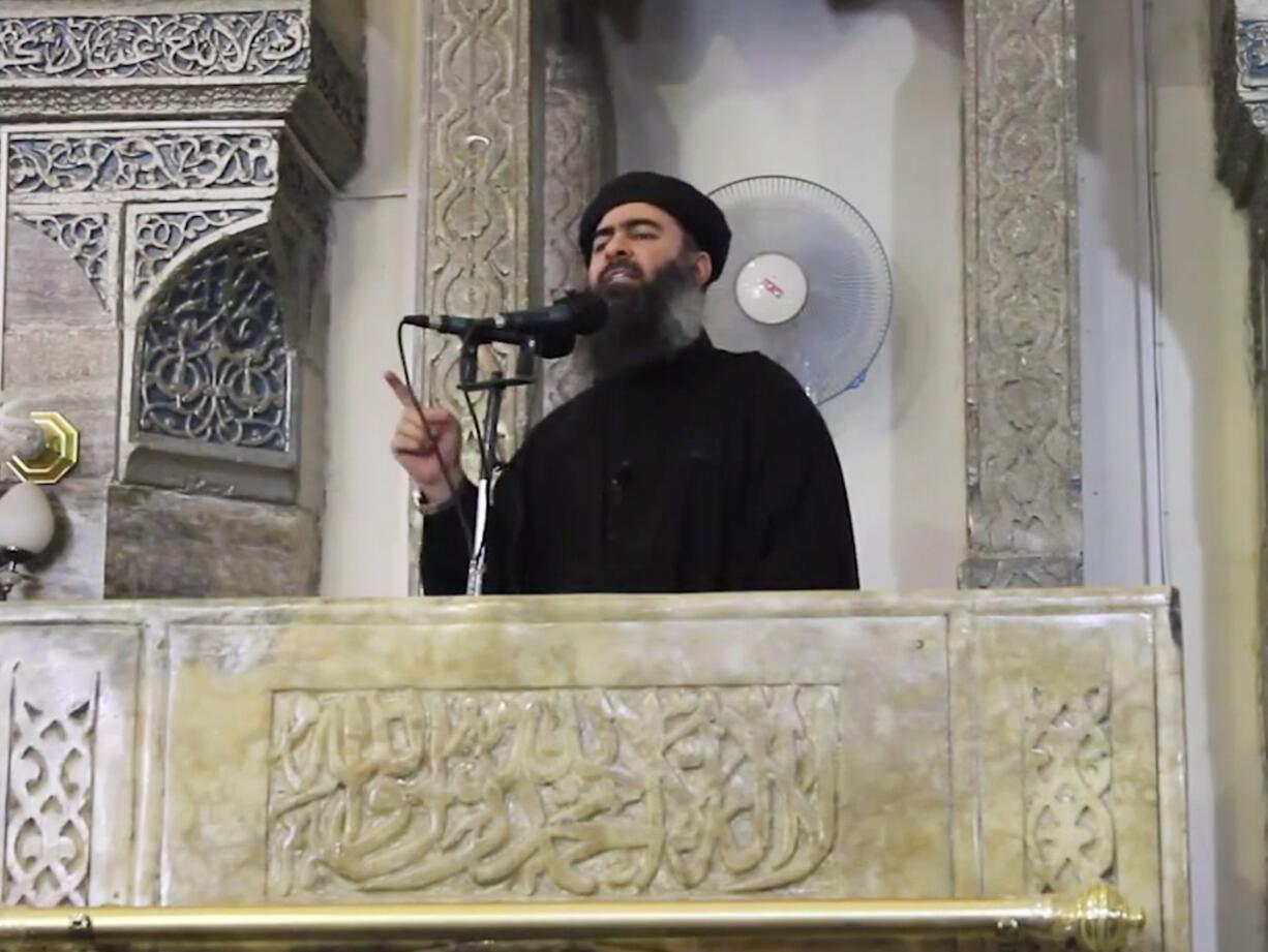 This image made from video posted on a militant website Saturday purports to show the leader of the Islamic State group, Abu Bakr al-Baghdadi, delivering a sermon at a mosque in Iraq.