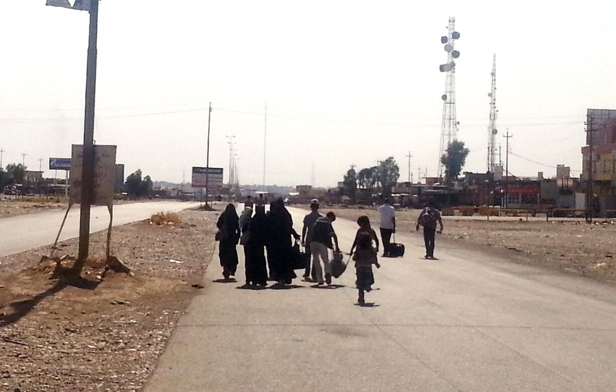 An Iraqi family leaves their hometown of Mosul, walking towards Irbil, Iraq, nearly a month after Islamic militants took over the countryu2019s second largest city.