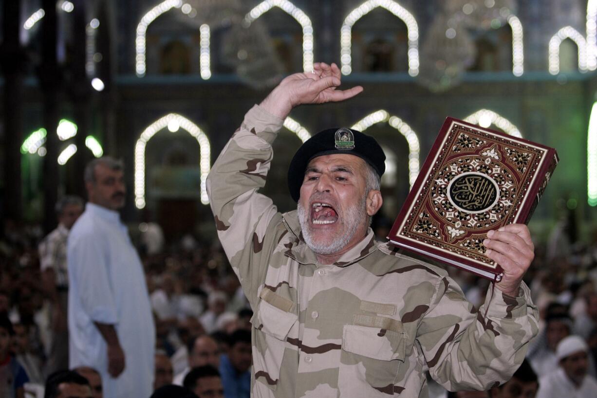 An Iraqi Shiite fighter chants slogans against the militant group Islamic State of Iraq and the Levant on Friday in the Shiite holy city of Karbala.