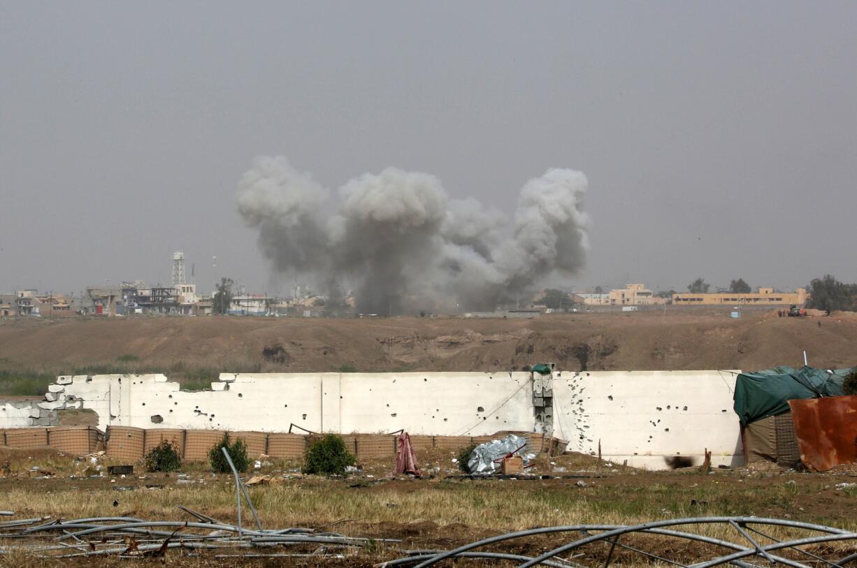 Smoke rises from central Tikrit as Iraqi security forces try to regain the city of Tikrit, 80 miles north of Baghdad, Iraq, on Monday