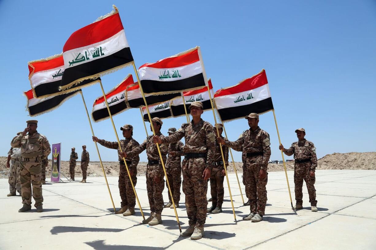 Sunni tribal volunteers with national flags stand in formation Wednesday during their graduation ceremony in Habaniyah, 80 kilometers (50 miles) west of Baghdad, Iraq. A month after the fall of Ramadi, the Shiite-dominated Iraqi government is working to train and equip Sunni tribesmen from Anbar to fight the Islamic State group.