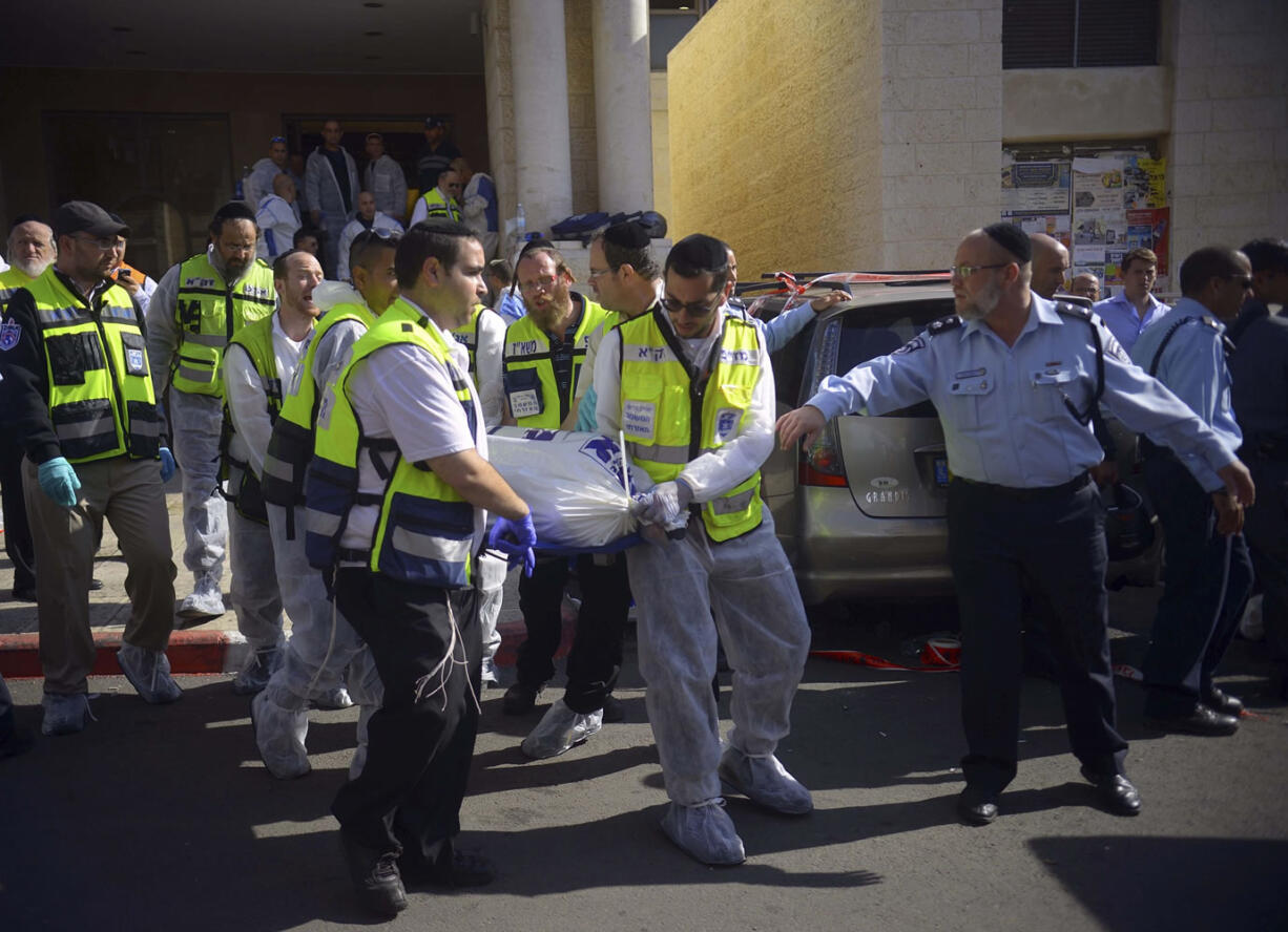 Paramedics carry a body out of a synagogue after an attack in Har Nof, an ultra-Orthodox neighborhood on the western edge of Jerusalem on Tuesday.