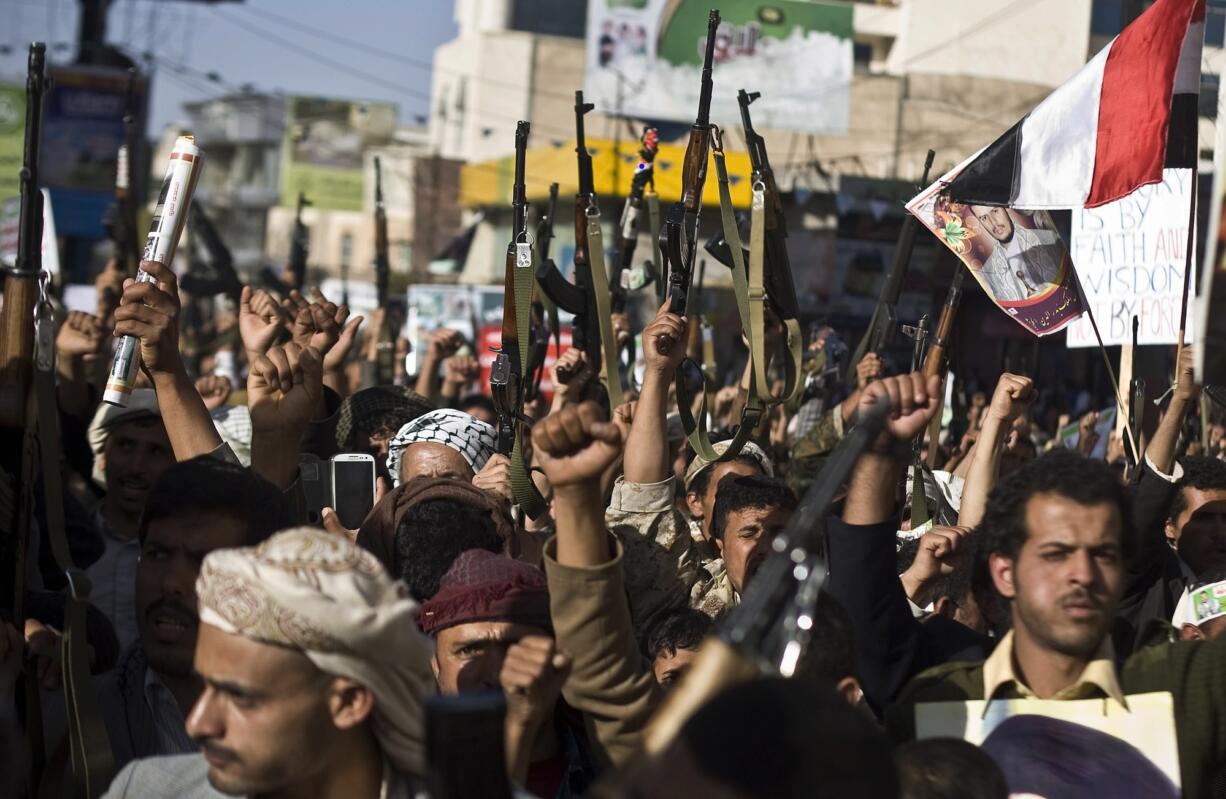 Shiite rebels known as Houthis hold up their weapons as they chant slogans during a protest to denounce the Saudi aggression in Sanaa, Yemen, on Wednesday.