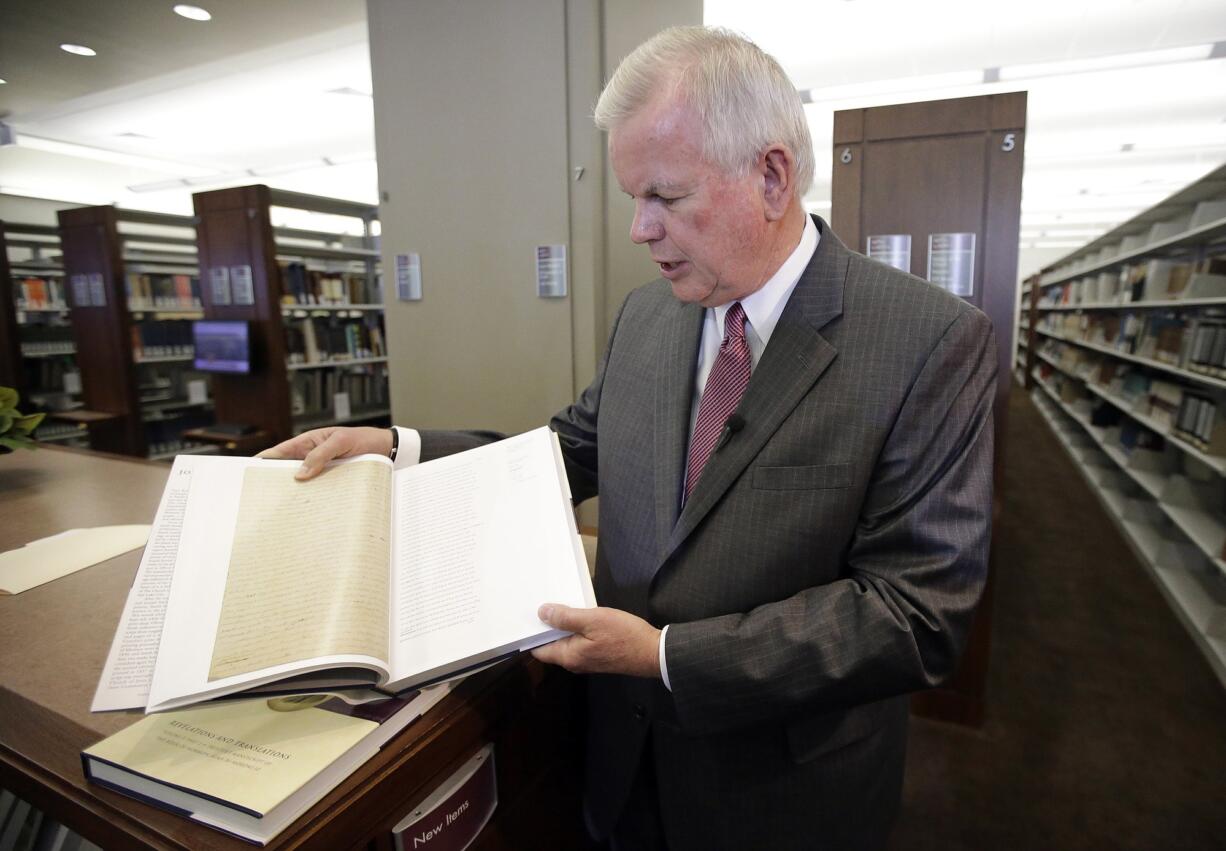 Photos by Rick Bowmer/Associated Press
Steven E. Snow, the Church of Jesus Christ of Latter-day Saints historian, displays the third volume of the Joseph Smith Papers, which includes the printer's manuscript of the Book of Mormon, during a news conference Tuesday in Salt Lake City. Membership in the church has tripled over the pas three decades.