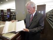 Photos by Rick Bowmer/Associated Press
Steven E. Snow, the Church of Jesus Christ of Latter-day Saints historian, displays the third volume of the Joseph Smith Papers, which includes the printer's manuscript of the Book of Mormon, during a news conference Tuesday in Salt Lake City. Membership in the church has tripled over the pas three decades.