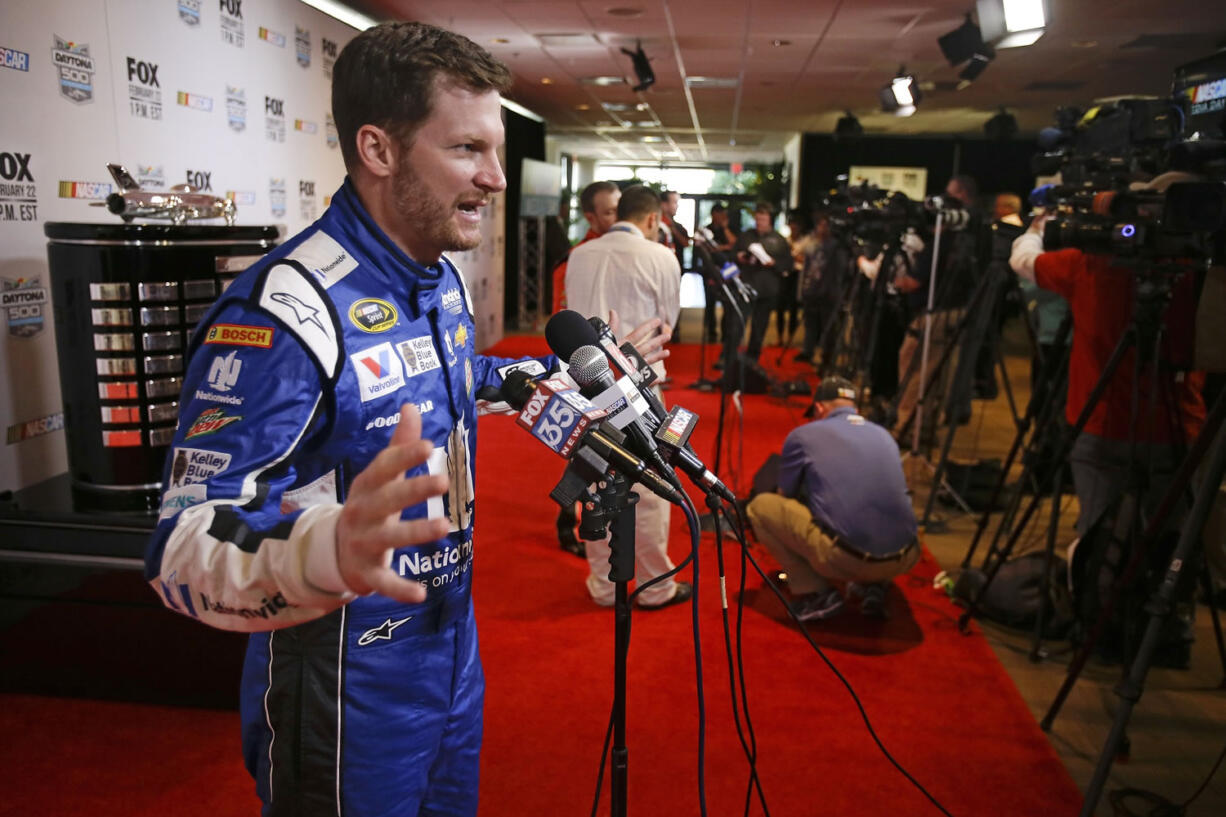 Dale Earnhardt Jr. talks with reporters during NASCAR media day at Daytona International Speedway, Thursday, Feb. 12, 2015, in Daytona Beach, Fla.