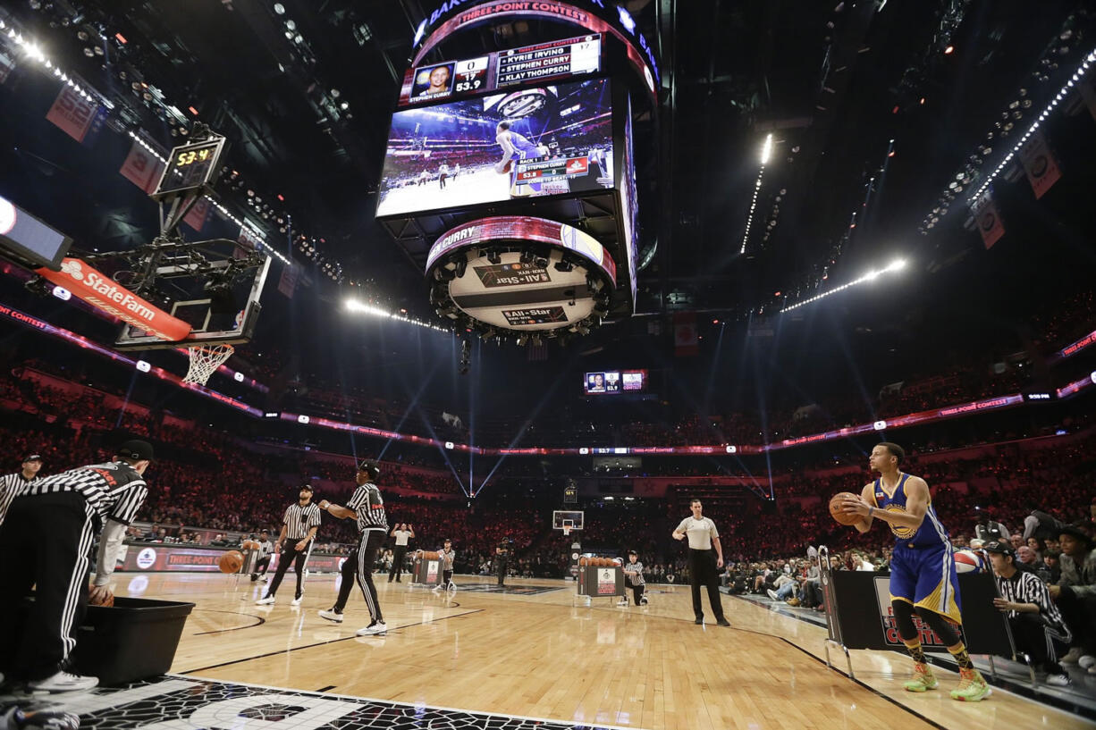 Golden State Warriors' Stephen Curry, right, competes during the NBA All-Star Saturday 3-point basketball contest Saturday, Feb. 14, 2015, in New York.