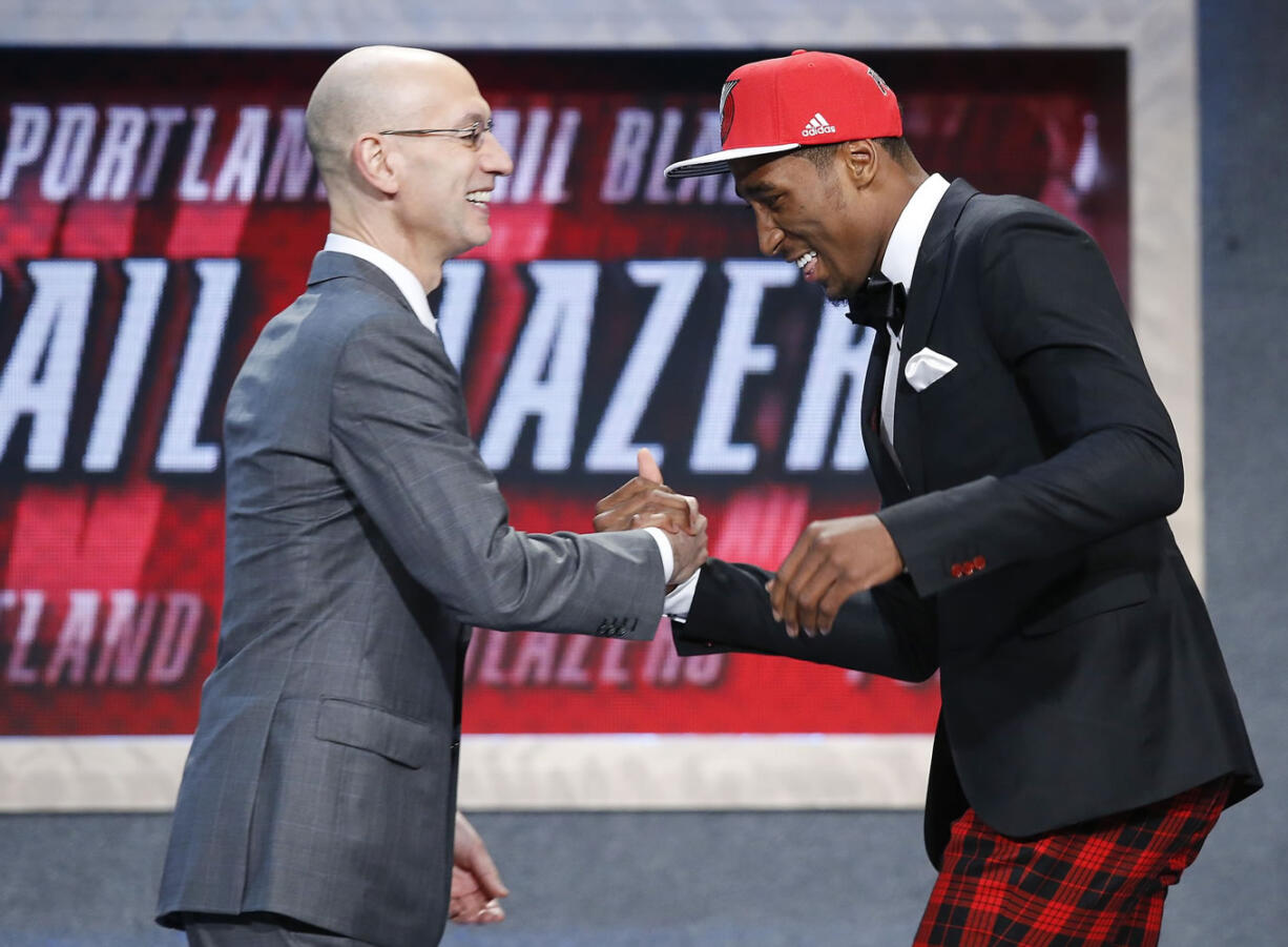 Rondae Hollis-Jefferson, right, greets NBA Commissioner Adam Silver after being selected 23rd overall by the Portland Trail Blazers during the NBA draft, Thursday, June 25, 2015, in New York.