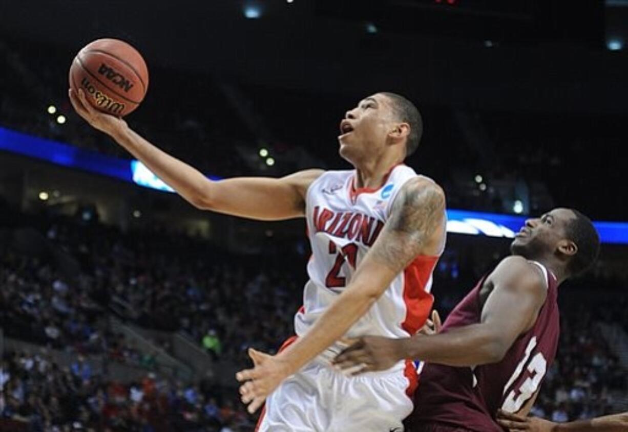 Arizona forward Brandon Ashley, left, goes to the basket against Texas Southern forward Nick Shepherd during the first half of an NCAA college basketball second round game in Portland, Ore., Thursday.