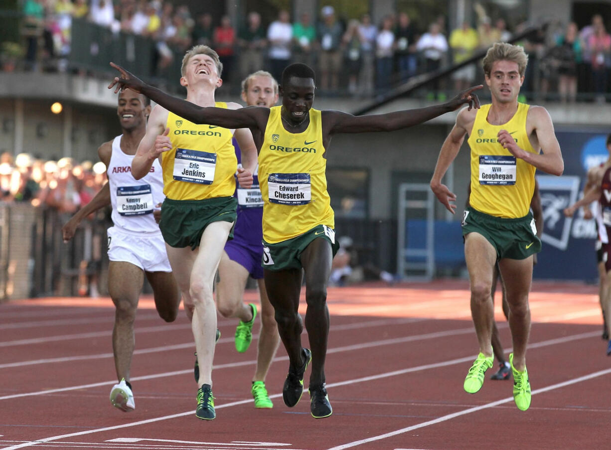 Oregon's Edward Cheserek crosses the finish line to win the men's 5,000 meter run, sealing the Ducks' NCAA men's team title on Friday at Hayward Field in Eugene.