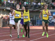 Oregon's Edward Cheserek crosses the finish line to win the men's 5,000 meter run, sealing the Ducks' NCAA men's team title on Friday at Hayward Field in Eugene.