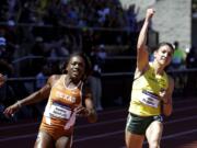 Oregon's Jenna Prandini, right, celebrates winning the women's 100 meters ahead of Texas' Morolake Akinosun during the NCAA track and field championships in Eugene, Ore., Saturday, June 13, 2015. Akinosun finished second.