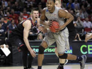 Eastern Washington forward Felix Van Hofe, left, reacts as Georgetown forward Mikael Hopkins drives past him during the second half of an NCAA college basketball second round game in Portland, Ore., Thursday, March 19, 2015.