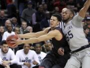 Eastern Washington guard Tyler Harvey, left,holds the ball away from Georgetown guard Jabril Trawick during the first half of an NCAA college basketball second round game in Portland, Ore., Thursday, March 19, 2015.