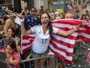 Lucie Keleman of New York's Westchester County cheers as U.S. Women's World Cup soccer champions make their way up Broadway to City Hall, during a ticker tape parade honoring the team Friday in New York. (AP Photo/Bryan R.