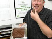 Zoovio co-owner Marlo Anderson eats some homemade fudge June 16 as he poses for photos on National Fudge Day at his Mandan, N.D., business.