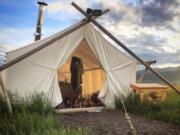 Kyra Melchor, 5, right, and her sister Elly Melchor, 9, relax inside a &quot;glamping&quot; tent in West Yellowstone, Mont.