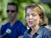 Brandie Smith, associate director of Animal Care Sciences at the Smithsonian's National Zoo, speaks Wednesday at the zoo in Washington. The zoo announced Friday that the surviving panda cub is male and the son of the zoo's male panda Tian Tian. Mei Xiang gave birth to fraternal twins Saturday, but the smaller cub -- also a male fathered by Tian Tian -- died Wednesday.