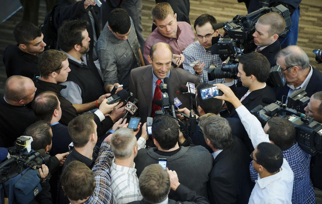 Nebraska's new football coach Mike Riley is swarmed by the media after a news conference at Memorial Stadium on Friday, Dec. 5, 2014 in Lincoln, Neb. Riley, who came from Oregon State, replaces Bo Pelini who was fired last Sunday.