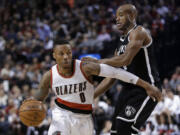 Portland Trail Blazers guard Damian Lillard, left, drives against Brooklyn Nets' Jarrett Jack during the second half Saturday, Nov. 15, 2014. Lillard led the Trail Blazers in scoring with 28 points as they won 97-87.