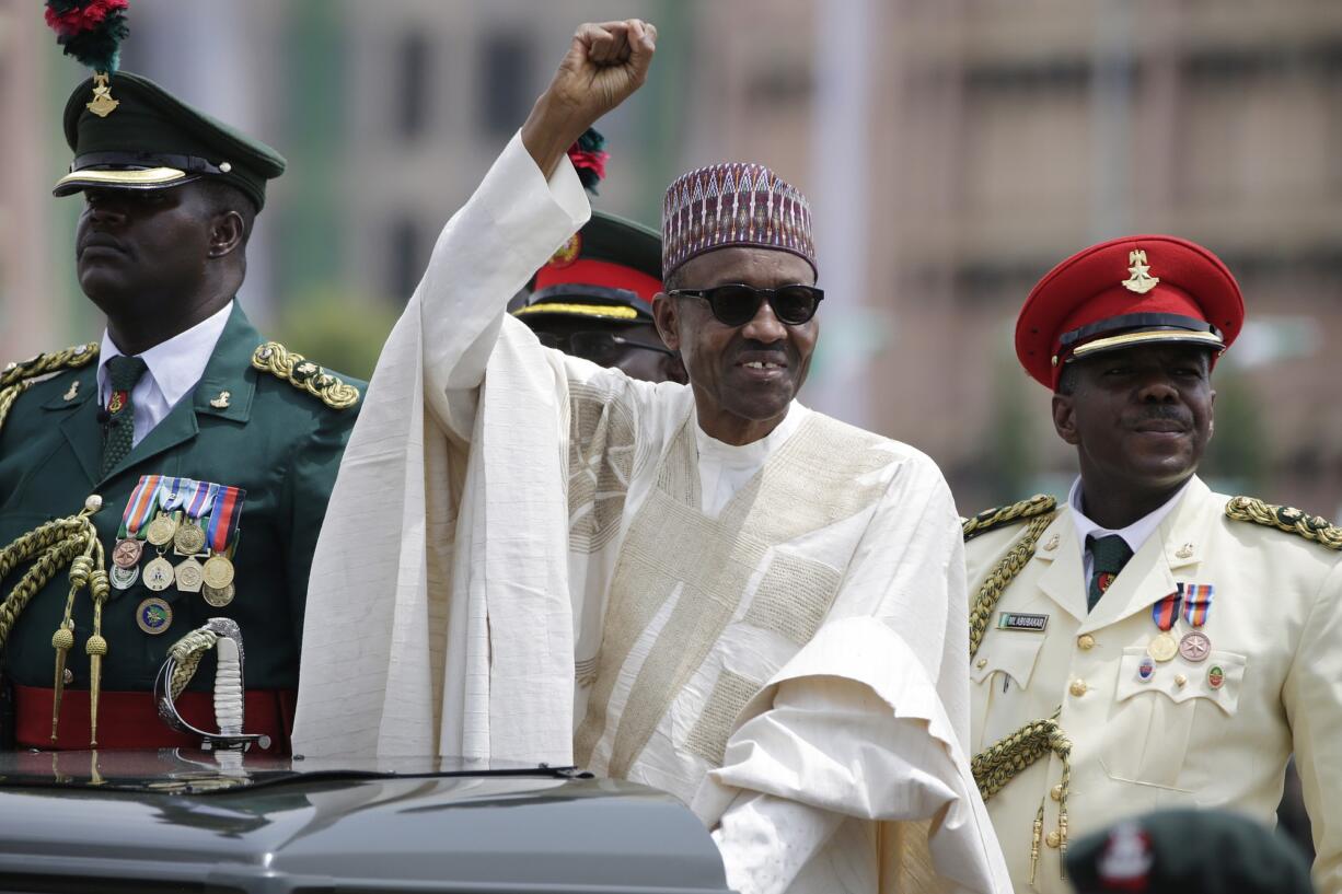 New Nigerian President Muhammadu Buhari salutes his supporters during his Inauguration Friday in Abuja, Nigeria.