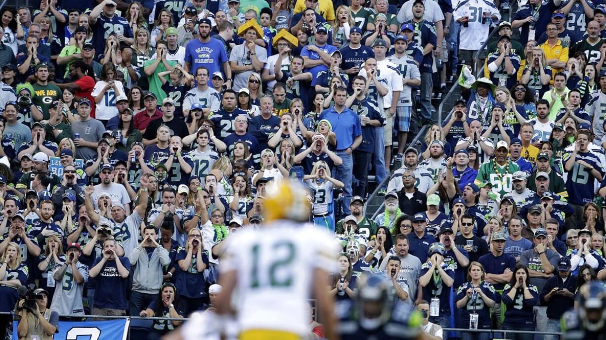 Seattle Seahawks fans try to disrupt the Green Bay offense as Packers quarterback Aaron Rodgers (12) tries to run a play during the Sept.