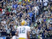 Seattle Seahawks fans try to disrupt the Green Bay offense as Packers quarterback Aaron Rodgers (12) tries to run a play during the Sept.