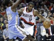 Portland Trail Blazers forward LaMarcus Aldridge, right, drives on Denver Nuggets forward Kenneth Faried during the second half Sunday, Nov. 9, 2014. Aldridge topped the Trail Blazers in scoring with 28 points as they won 116-100.