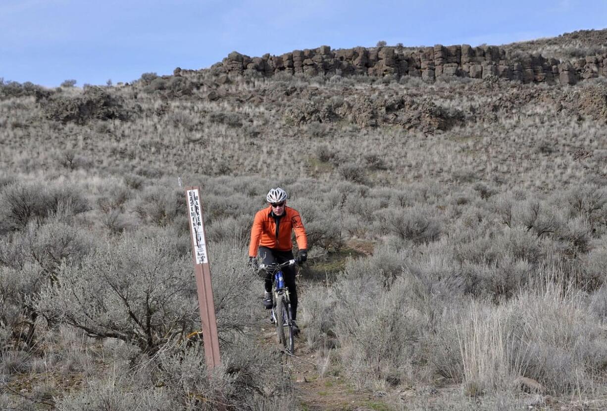 Spokane mountain biker Steve Weinberger follows the markers for the Odessa-Pacific Lake Trail near Odessa.