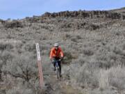 Spokane mountain biker Steve Weinberger follows the markers for the Odessa-Pacific Lake Trail near Odessa.