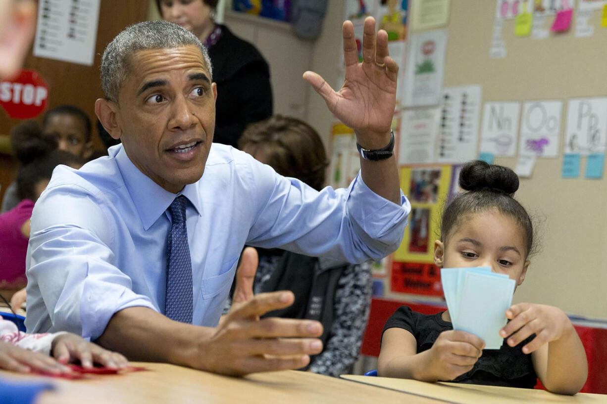 President Barack Obama visits with 3 to 5 year-olds at the Community Children's Center in Lawrence, Kan., on Thursday before speaking about the themes in his State of the Union address.