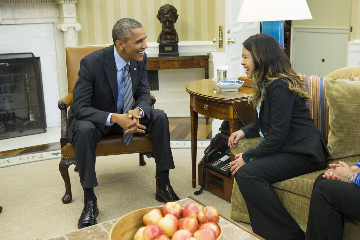 President Barack Obama meets with Ebola survivor Nina Pham on Friday in the Oval Office of the White House in Washington. Pham, the first nurse diagnosed with Ebola after treating an infected man at a Dallas hospital is free of the virus. The 26-year-old Pham arrived last week at the NIH Clinical Center.