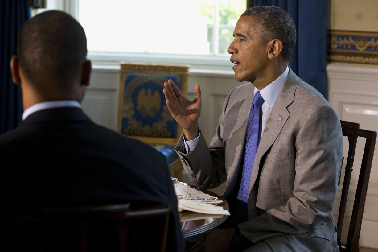 President Barack Obama hosts teachers for lunch Monday in the Blue Room of the White House in Washington.