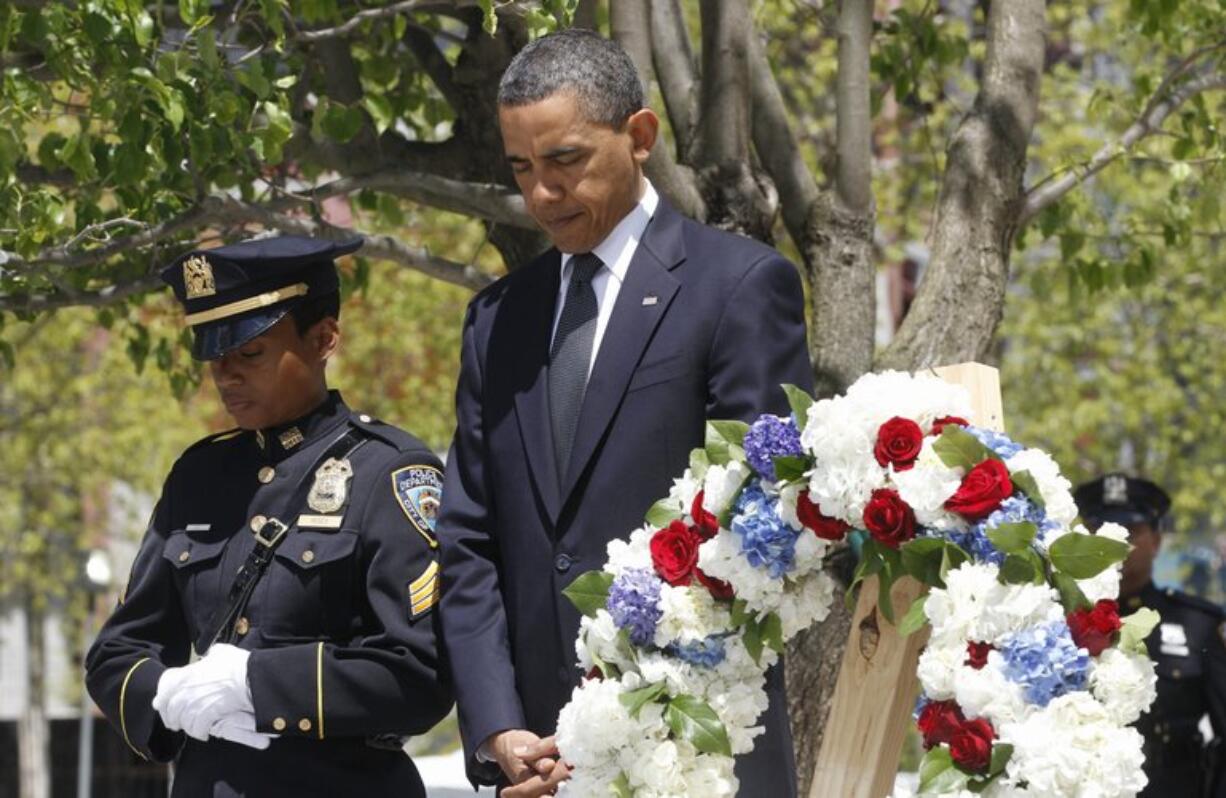 President Barack Obama pauses after laying a wreath Thursday at the National Sept.