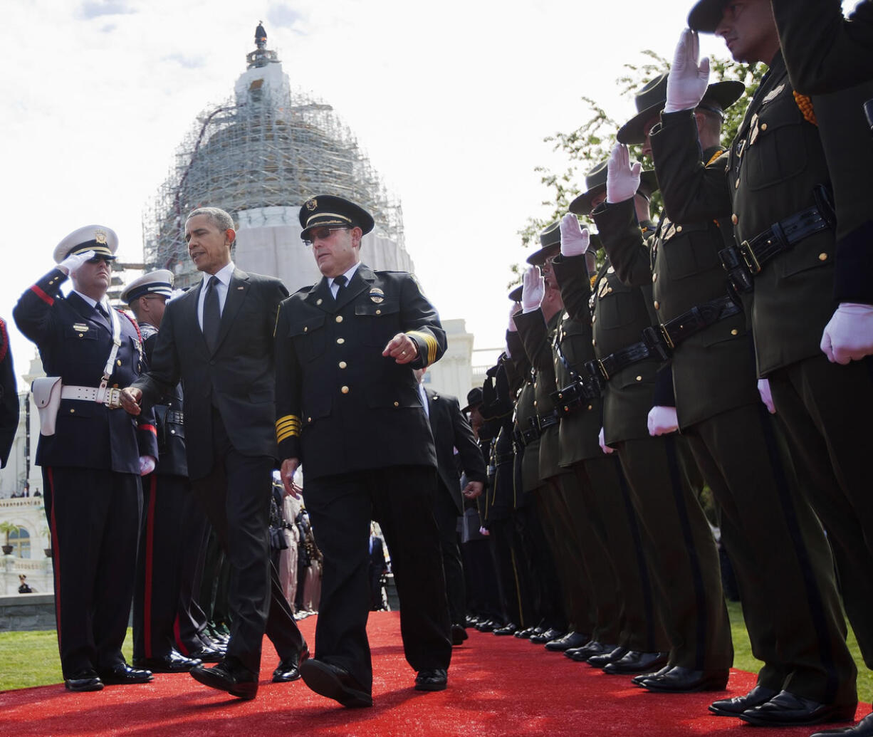 President Barack Obama walks Friday with Chuck Canterbury, president of the Grand Lodge Fraternal Order of Police, right, on Capitol Hill in Washington, during the 34th annual National Peace Officers Memorial Service, honoring law enforcement officers who died in the line of duty.