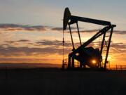 A Whiting Petroleum Co. pump jack pulls crude oil from the Bakken region of the Northern Plains near Bainville, Mont.