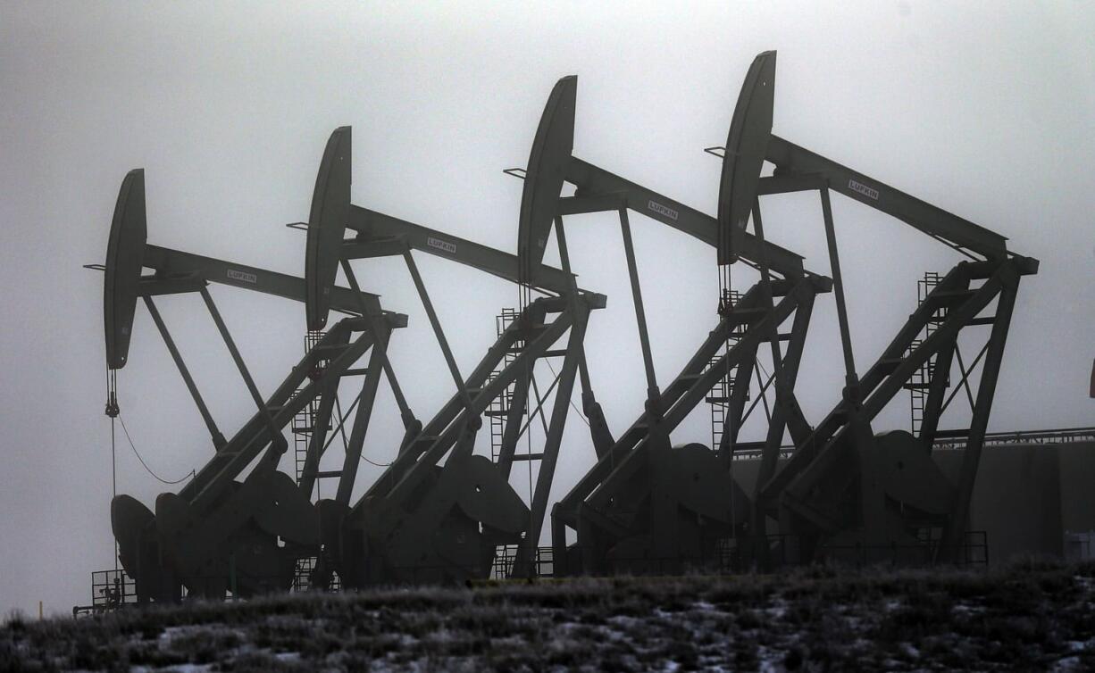 Eric Gay/Associated Press
Oil pump jacks work in unison, in Williston, N.D. After falling nearly 60 percent from a peak last June, the price of oil has bounced back more than 20 percent since late January.