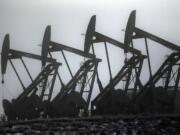 Eric Gay/Associated Press
Oil pump jacks work in unison, in Williston, N.D. After falling nearly 60 percent from a peak last June, the price of oil has bounced back more than 20 percent since late January.