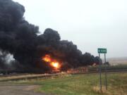 This photo provided by Curt Bemson shows smoke and fire coming from an oil train that derailed Wednesday, May 6, 2015 in Heimdal, North Dakota. Officials say ten tanker cars on the BNSF caught fire prompting the evacuation of Heimdal where about three dozen people live.