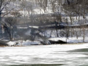 Associated Press files
A train derailment sent a tanker with crude oil into the Kanawha River on Feb. 17 near Mount Carbon, W.Va. Four trains hauling crude oil have derailed in the U.S. and Canada since mid-February, rupturing tank cars, spilling their contents, polluting waterways and igniting spectacular fires that burned for days.