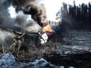 A ruptured tank car burns after a crude oil train derailment Feb.