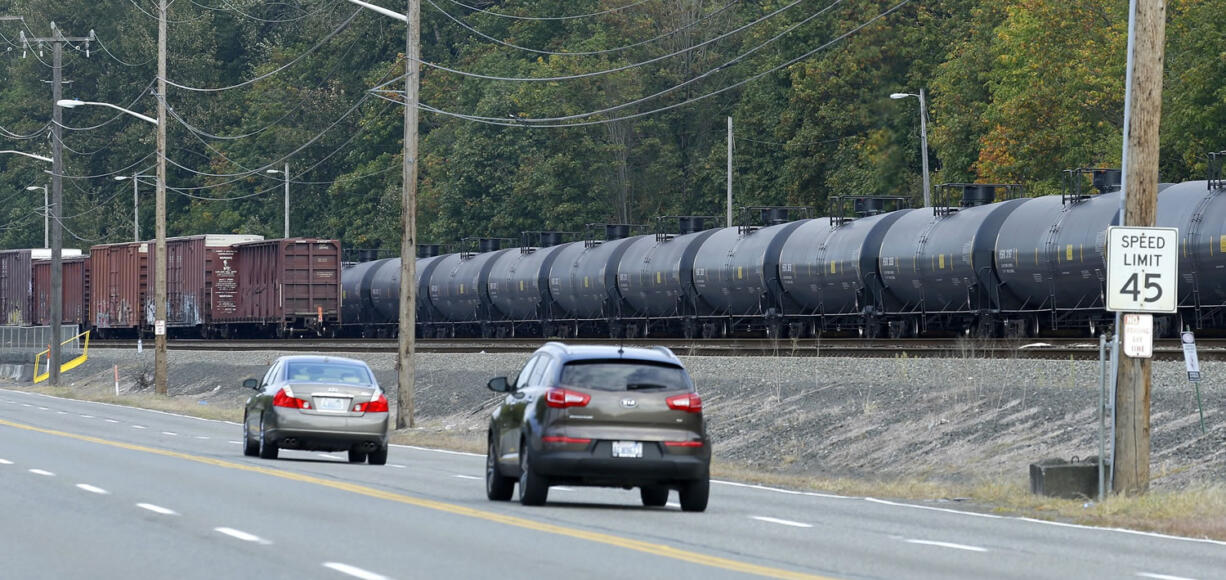 A long line of rail cars containing oil sit on tracks south of Seattle in September.