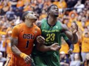 Oregon forward Elgin Cook, right, jockeys for position with Oregon State guard Gary Payton II during the second half in Corvallis, Ore., Wednesday, March 4, 2015. Cook led Oregon in scoring with 17 points as they beat Oregon State 65-62.