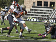 Oregon State running back Terron Ward (28) scores a touchdown against Colorado in the first half at Boulder, Colo., on Saturday, Oct. 4, 2014.