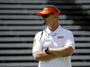 FILE - In this April 18, 2015, file photo, Oregon State football coach Gary Anderson watches during the first half of the NCAA college football team's spring game in Corvallis, Ore.  It is definitely a time of change for the Beavers with a new coach, a new system, and, if Andersen has his way, a new culture of winning.