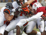 Oregon State's Chris Brown, center, fights his way into the end zone for a touchdown Saturday at Stanford, but little went well for the Beavers.