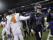 Washington quarterback Cyler Miles (10) gets a pat from Oregon State quarterback Sean Mannion after an NCAA college football game Saturday, Nov. 22, 2014, in Seattle. Washington won 37-13.