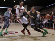 Oregon's Dillon Brooks (24) dribbles against Stanford's Anthony Brown (21) during the second half of an NCAA college basketball game in Stanford, Calif., Sunday, March 1, 2015. Oregon won 73-70.